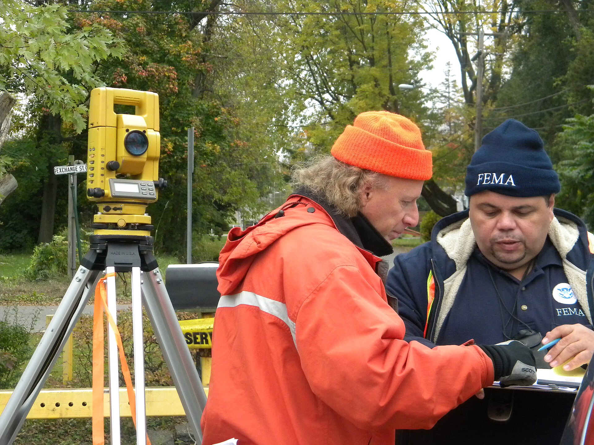 Surveyors taking field measurements with surveying instruments